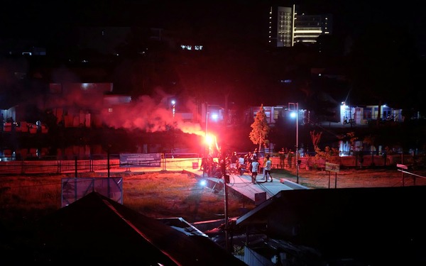 Floodlight pylons burning over a suburban Australian sports ground at night
